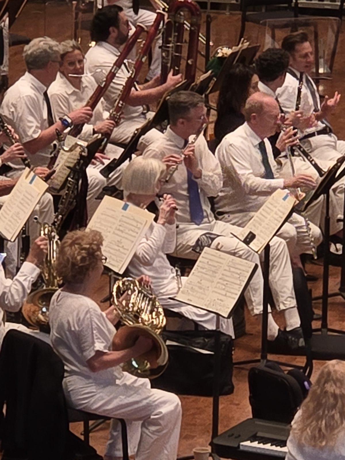 Members of the Chautauqua orchestra in white, mid-performance