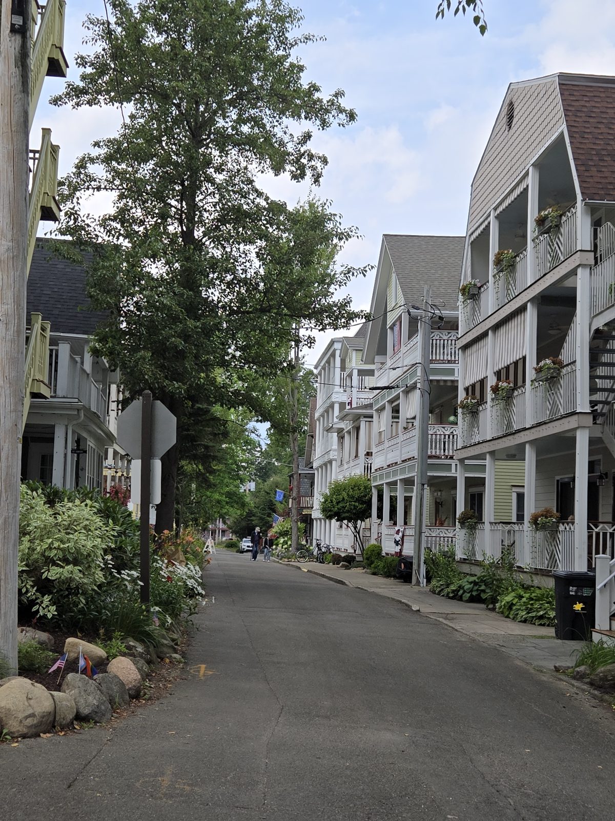 A narrow tree-lined street of tall Victorian houses with porches at Chautauqua